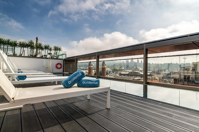 "Rooftop pool at Occidental hotel in Barcelona with city views"